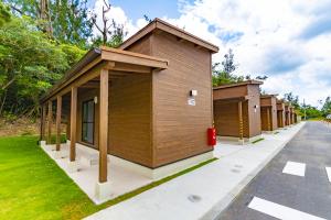 a row of small buildings on a street at Beach Resort Hotel Kalakaua in Onna