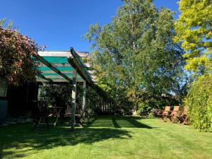 a gazebo with a table and chairs in a yard at High Country Cottage in Twizel