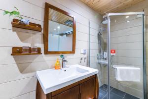 a bathroom with a sink and a shower at Wenjun Courtyard Hotel ---5 mins walk from Tonghuimen metro station, near Tianfu square, close by culture park and Sichuan opera house, English speaking service, local tours in Chengdu