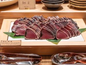 a bunch of meat on a display case in a store at APA Hotel Shin Osaka Ekimae in Osaka