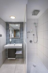 a bathroom with a sink and a shower at Oasis Hotel in Kuwait