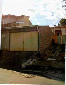 un bâtiment en briques avec un portail et un garage dans l'établissement Casa conforto, à Lavrinhas