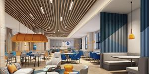 a restaurant with tables and chairs and blue chairs at Holiday Inn Express Shanghai Baoyang, an IHG Hotel in Baoshan