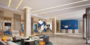 a lobby of a hotel with chairs and tables at Holiday Inn Express Shanghai Baoyang, an IHG Hotel in Baoshan