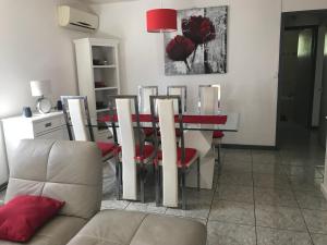 a dining room with a red table and chairs at Les Bungalows du Mont-Auban in Sainte-Clotilde