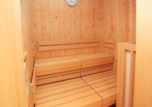 a wooden sauna with a clock on the wall at Urban Hotel Kyoto Gojo Premium in Kyoto
