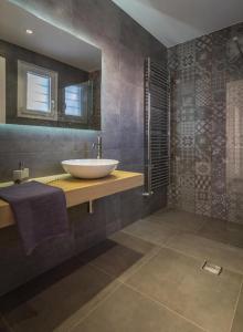 a bathroom with a sink and a mirror at Milos Waves Luxury Apartments in Pollonia +37 photos