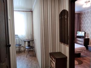 a room with a bed and a table and a window at центр вулиця Миру in Shostka