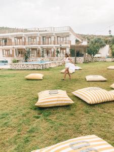 a woman playing with a frisbee in a field at Alaçatı Barbarossa Hotel in Cesme
