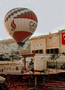 a hot air balloon is flying over a table at Caftan Cave Suites in Goreme