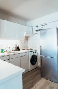 a kitchen with a refrigerator and a dishwasher at Appartement Val Rose II, 11de verdieping in Blankenberge