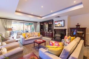 a living room with couches and a tv at Courtyard Hotel Rosebank in Johannesburg