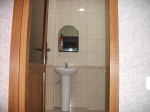 a bathroom with a sink and a mirror at Guesthouse on Kabardinskaya 139a in Gagra