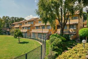 an apartment complex with a fence and a park at City Lodge Hotel Eastgate in Johannesburg