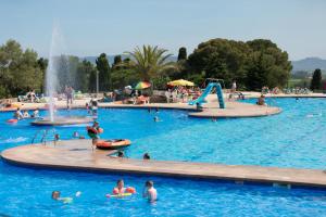 a large swimming pool with people in the water at Castell Montgri - Mobile Homes by Lifestyle Holidays in L'Estartit