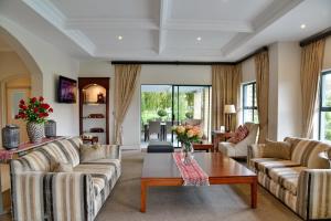 a living room with couches and a coffee table at City Lodge Hotel Eastgate in Johannesburg