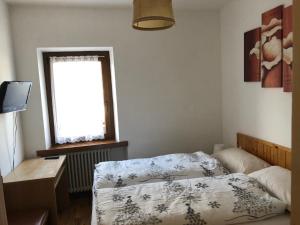 Ένα ή περισσότερα κρεβάτια σε δωμάτιο στο B&B Astor