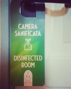 a green and white sign on a door at Hotel Villa Sophia in Sanremo