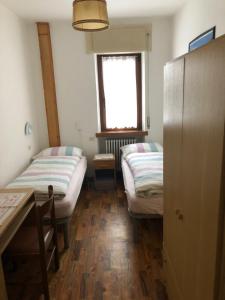 Ένα ή περισσότερα κρεβάτια σε δωμάτιο στο B&B Astor