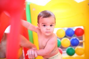 a baby playing in a toy play set at Nádas Tó Park Hotel in Vasad