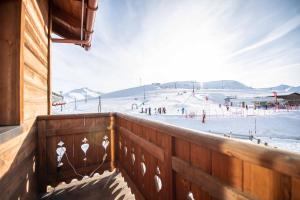 vistas a una pista de esquí desde el balcón de un lodge de esquí en Alpino Lodge Bivio, en Livigno