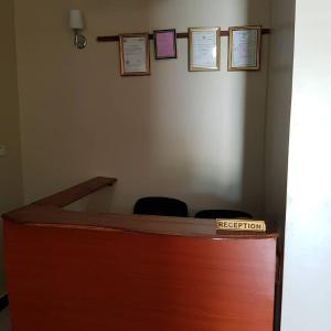 a reception desk with two chairs in a room at Prideinn Lodge Kigamboni in Dar es Salaam