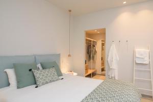 a bedroom with a large bed and a walk in closet at Vigla Hotel in Aegiali