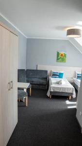 a living room with a bed and a couch at Ośrodek LZS CIS "Od Nowa" in Mielno +38 photos