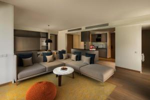 a living room with a couch and a table at Hyatt Delhi Residences in New Delhi