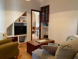 a living room with a couch and a coffee table at casa nuria, en el centro, al lado de la escalinata del calvario para 6 personas in Pollença