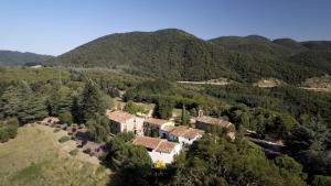 an aerial view of a house in the mountains at Masovería l'Era in Arbúcies