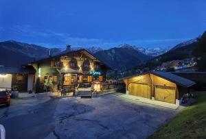 a large building with mountains in the background at Auberge la Tzoumaz in La Tzoumaz