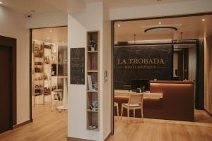 a restaurant with a table and chairs in a room at La Trobada Hotel Boutique in Ripoll