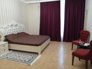 a bedroom with a bed and a table and chairs at Филадэльфия in Kislovodsk