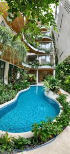 a swimming pool in the middle of a building at Cityhouse - CityOasis in Ho Chi Minh City