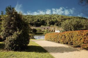 a walkway in front of a house with a waterfall at Comtesse de Dordogne in Les Eyzies-de-Tayac