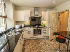 a kitchen with a sink and a stove top oven at Belle Vue in Ilkley