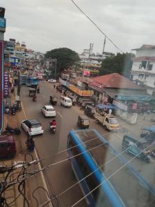 a busy city street with cars and buses at MALABAR Residency in Perintalmanna