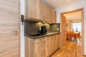 a kitchen with wooden cabinets and a dining room at Feichtenhof in Reit im Winkl