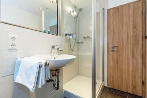 a white bathroom with a sink and a shower at Feichtenhof in Reit im Winkl