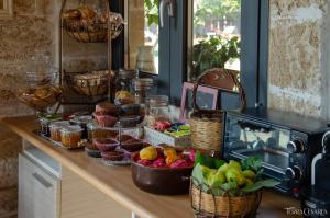 a counter with baskets of fruit on a table at B&B Terra Cesarea in Santa Cesarea Terme +30 photos