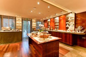 a kitchen with a island with food on it at Hotel Adler Asperg in Asperg