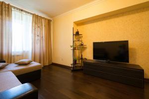 a living room with a flat screen tv on a wall at Nadezhda Apartment on Dostyk street 89 in Almaty