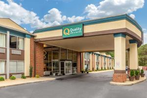 a building with a sign on the front of it at Quality Inn & Suites Apex-Holly Springs in Apex