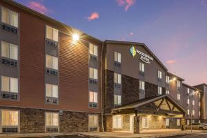 an exterior view of a hotel at night at WoodSpring Suites Detroit Farmington Hills in Farmington Hills