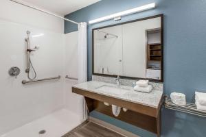 a bathroom with a sink and a mirror at WoodSpring Suites Detroit Farmington Hills in Farmington Hills +29 photos