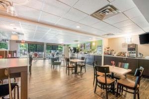 a restaurant with tables and chairs and a counter at Sleep Inn & Suites Dover in Dover