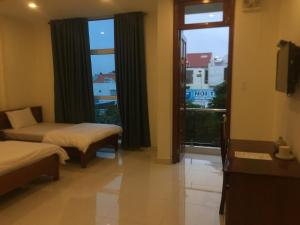 Postel nebo postele na pokoji v ubytování Nhà nghỉ Linh Quân