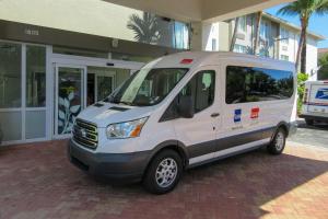 a white van parked in front of a building at Sleep Inn & Suites Ft Lauderdale International Airport in Dania Beach