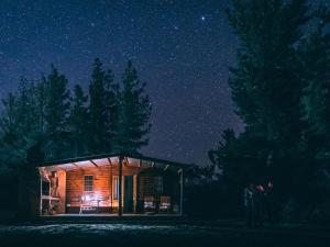a wooden cabin under a starry sky at night at Alpha Excelsior Guest Farm in Cederberg